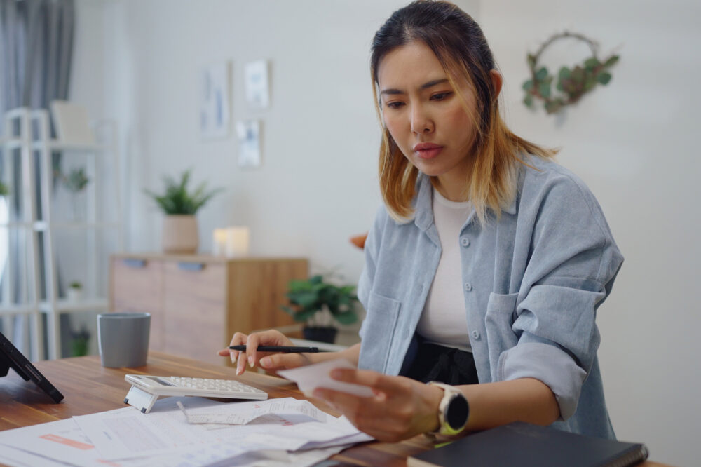 Concerned woman calculating home finances